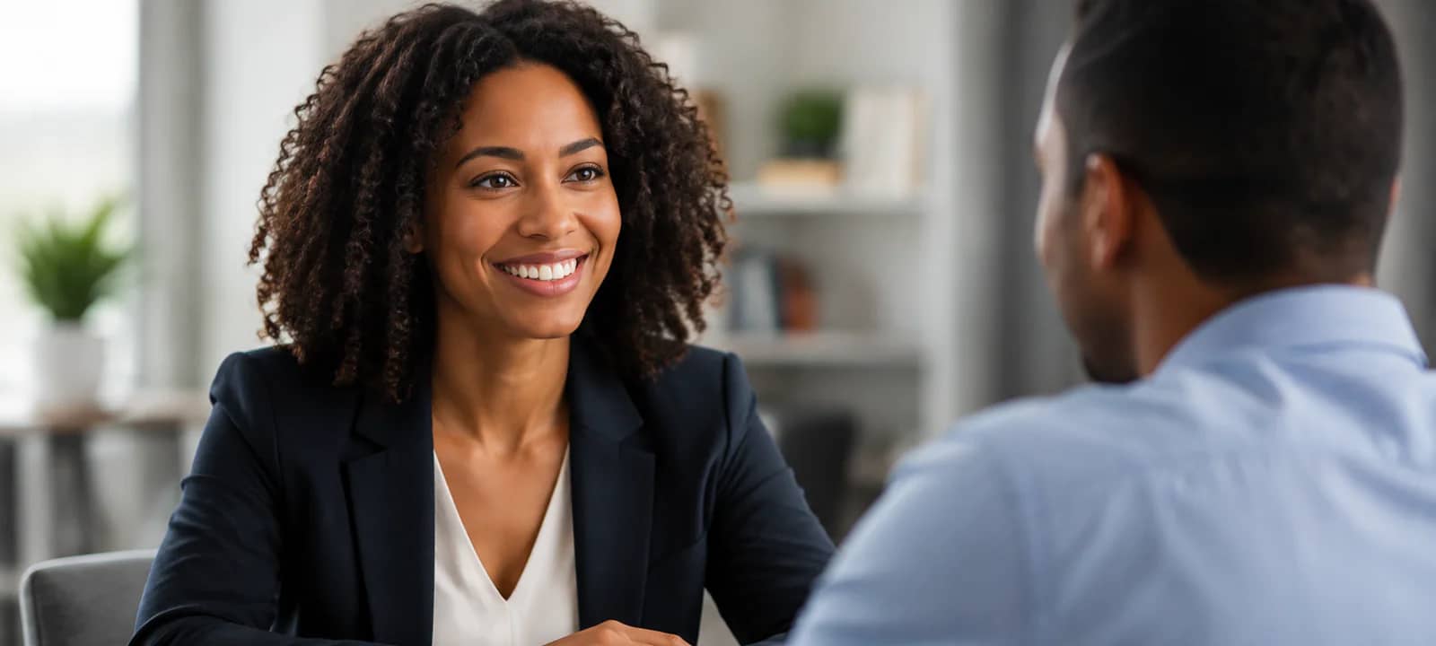 Bankruptcy attorney meeting with a prospective client in a bright office